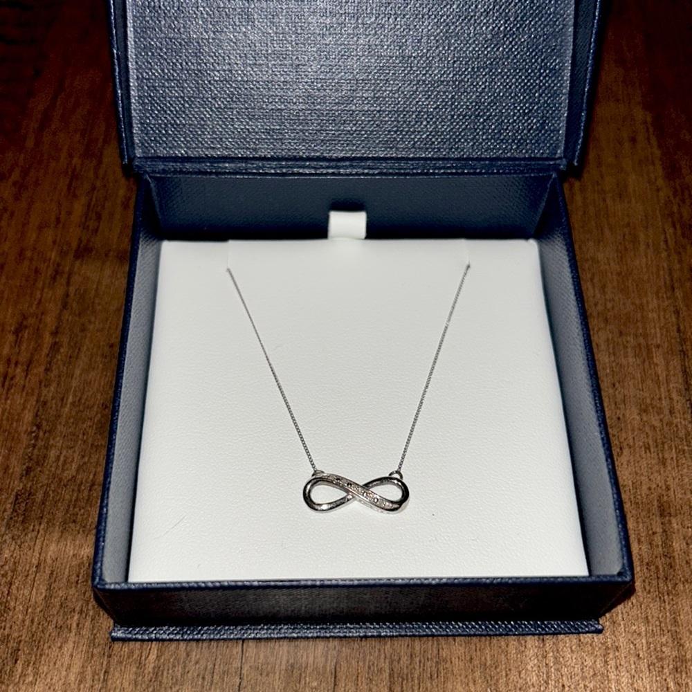 Alberts 10k white gold diamond infinity necklace. 18 inch chain